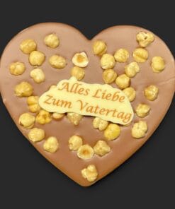 Schokoladenherz aus Vollmilchschokolade (40 % Kakao), mit Aufschrift „Schokoherz flach Vatertag Haselnüsse“