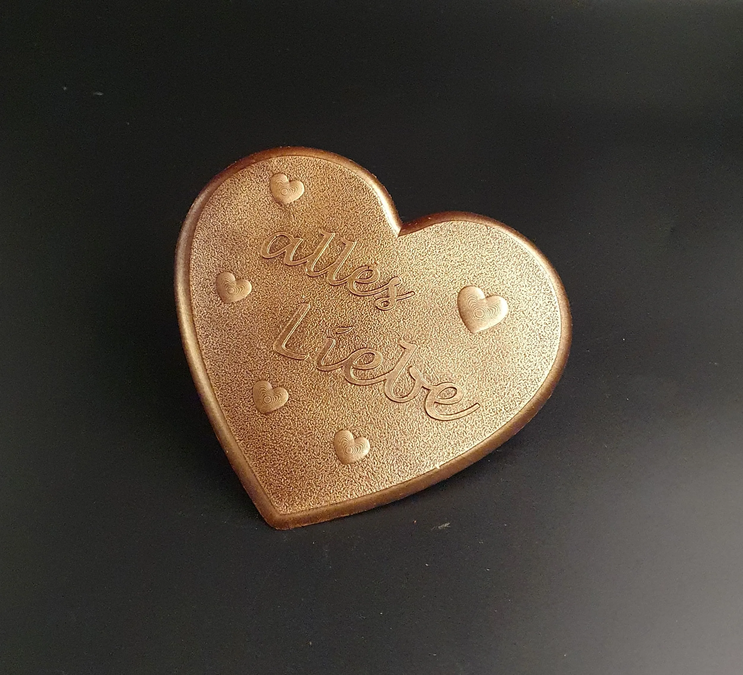 Dark chocolate heart with "all my love" lettering and bronze-colored food coloring
