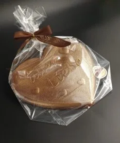 Heart made of dark chocolate with "all my love" lettering in bronze-colored food coloring, packaged