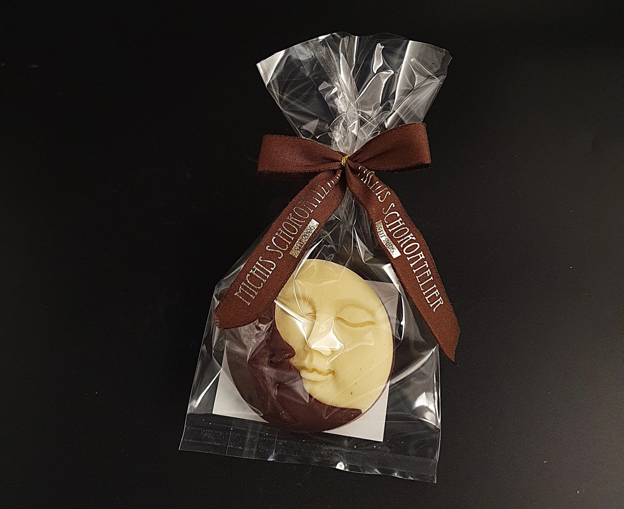 Sun &amp; Moon coins made from white, dark, and milk chocolate, packaged