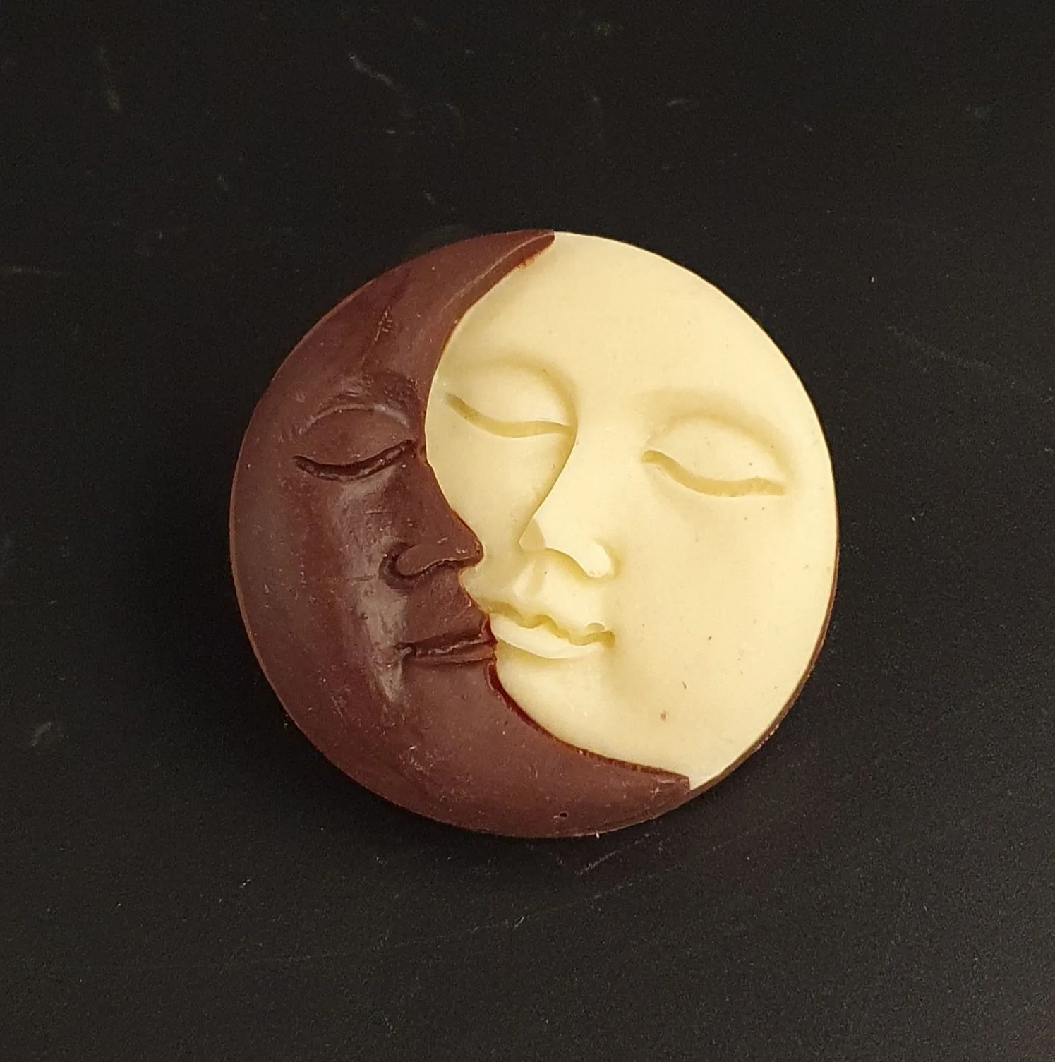 Sun and moon coins made from white, dark, and milk chocolate